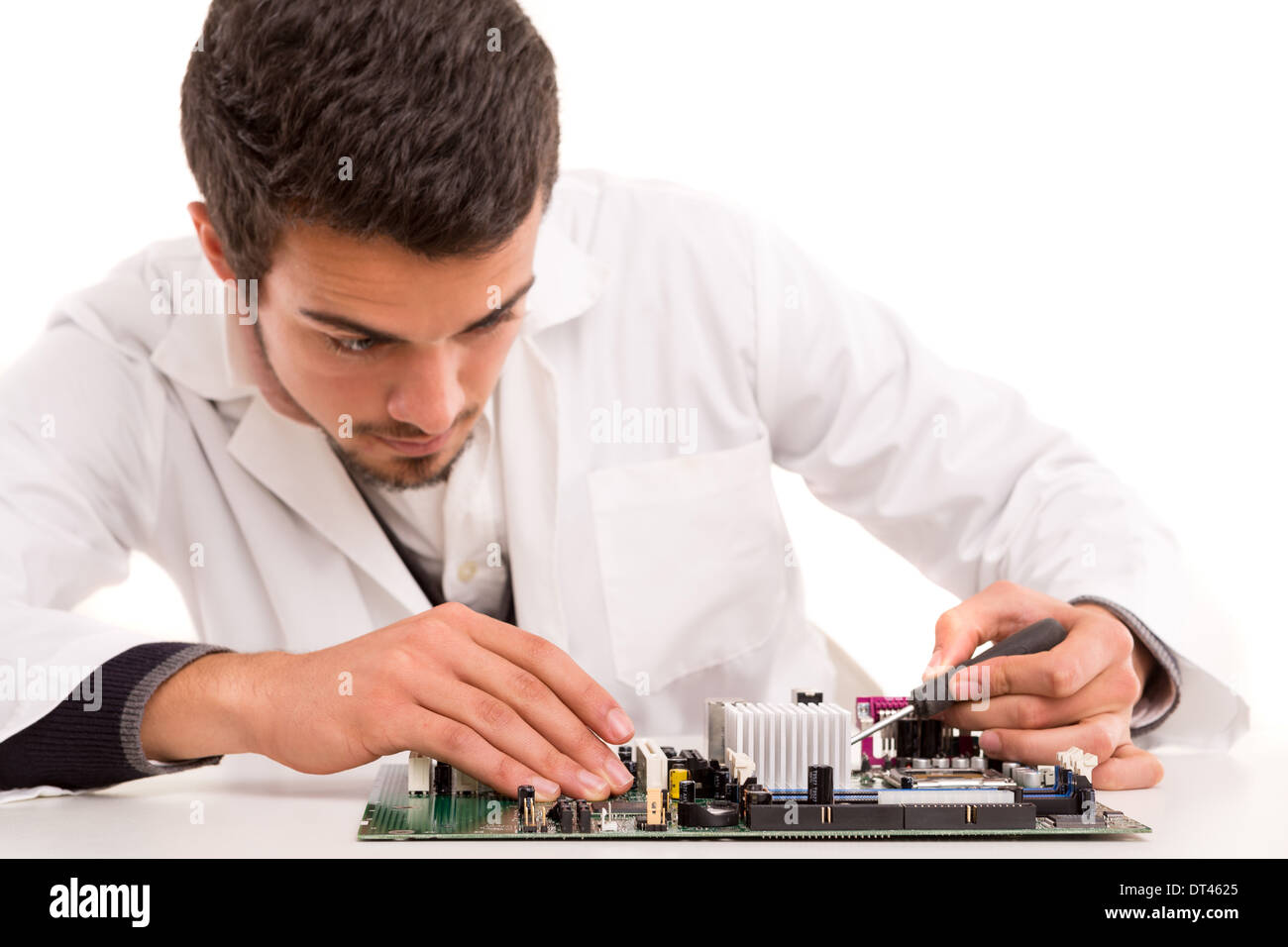 A computer engineer or technician, working on a computer motherboard Stock Photo