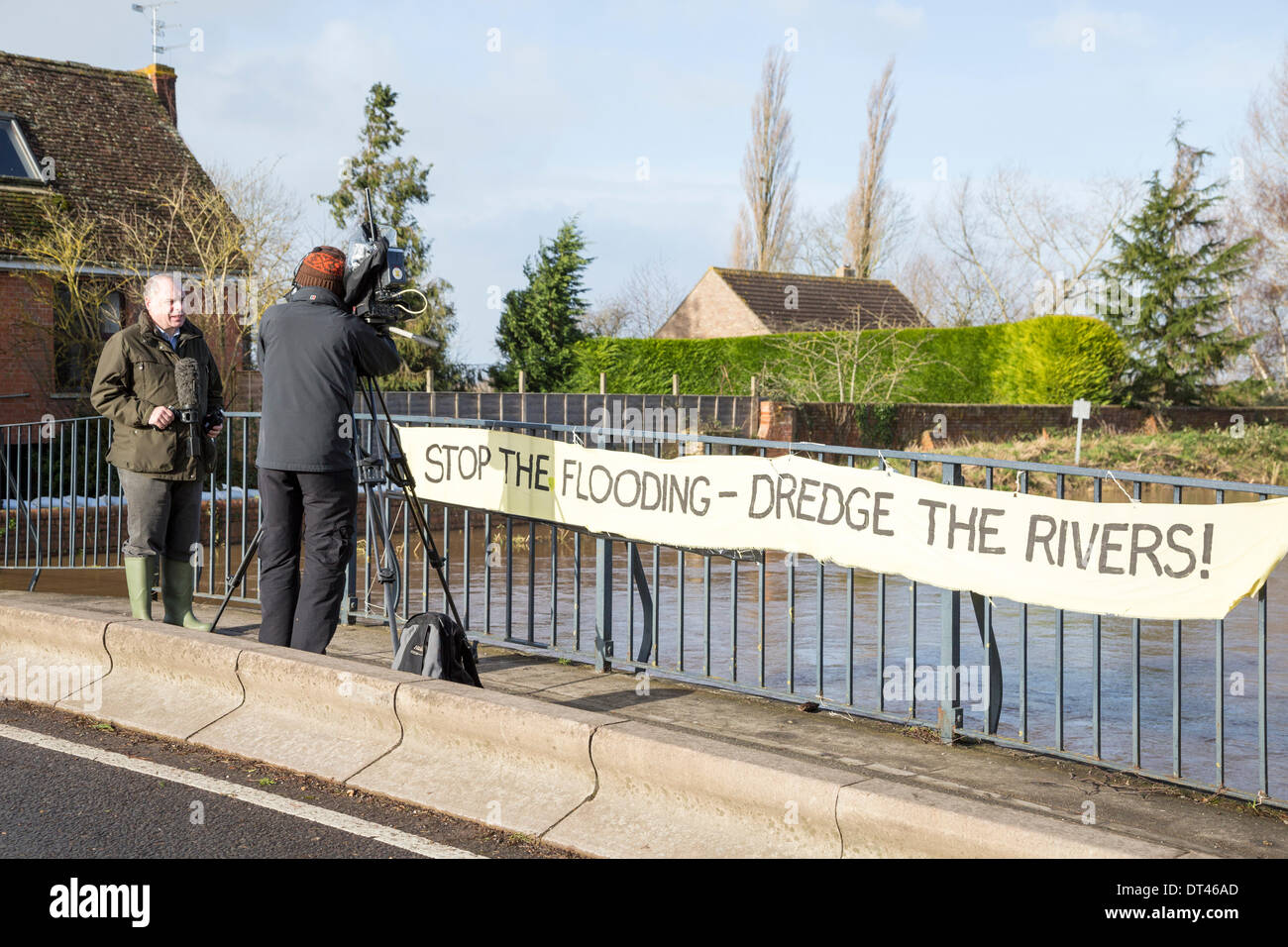 Burrowbridge, Somerset, UK. 8th February 2014. Conservative MP Mr Ian Liddell-Grainger being interviewed by BBC News on 8th February 2014 standing on the bridge over the River Parrett on the A361 at Burrowbridge, Somerset. Due to heavy rainfall, the rivers Parrett and Tone have burst their banks flooding nearby farmland and leaving houses underwater. Following visits by Lord Chris Smith and David Cameron yesterday, a severe flood alert remains and some occupants have been told to evacuate. The Somerset Levels have experienced the worst flooding in living history. Credit:  Nick Cable/Alamy Live Stock Photo