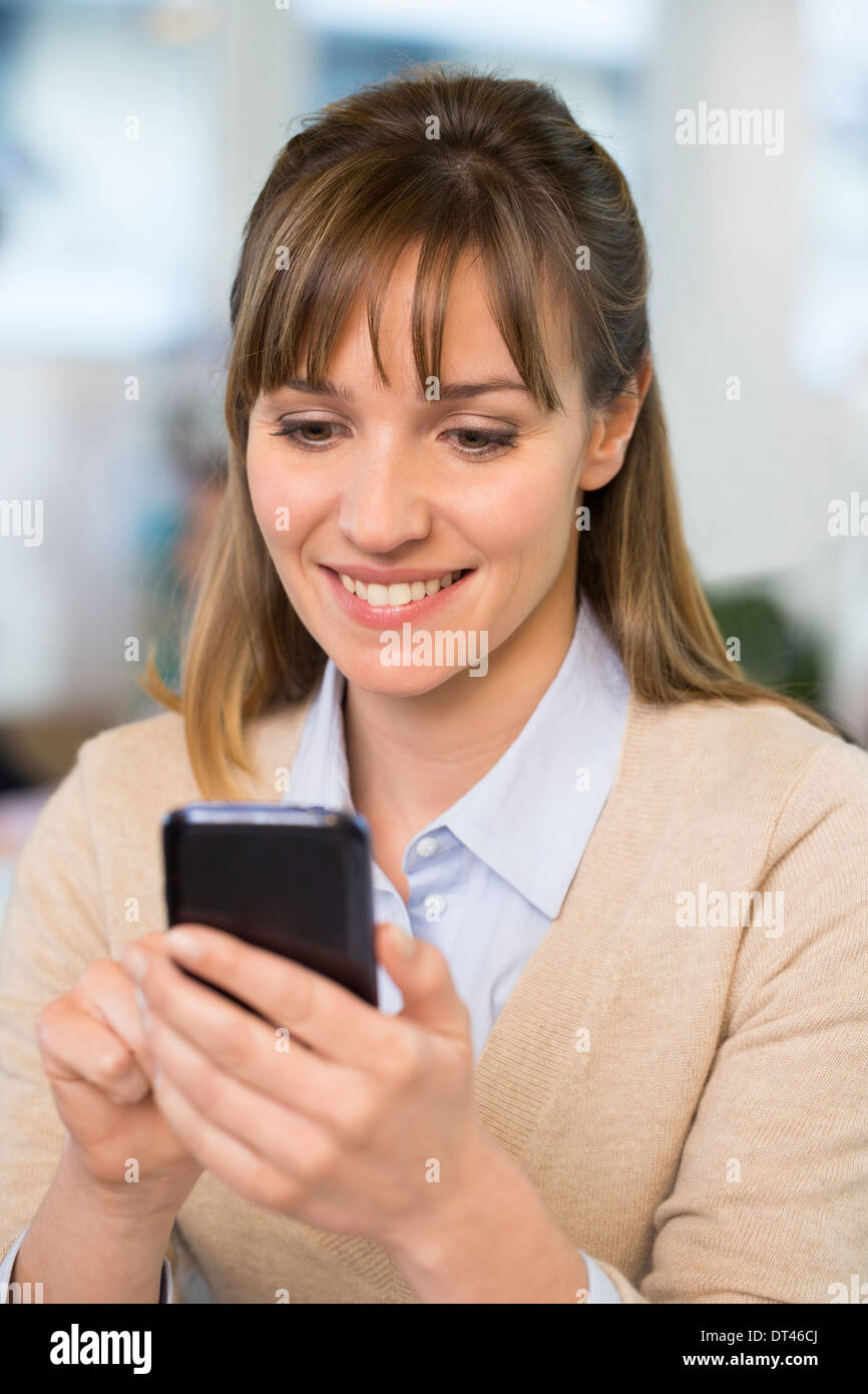 Female business cell phone desk typing Stock Photo Alamy