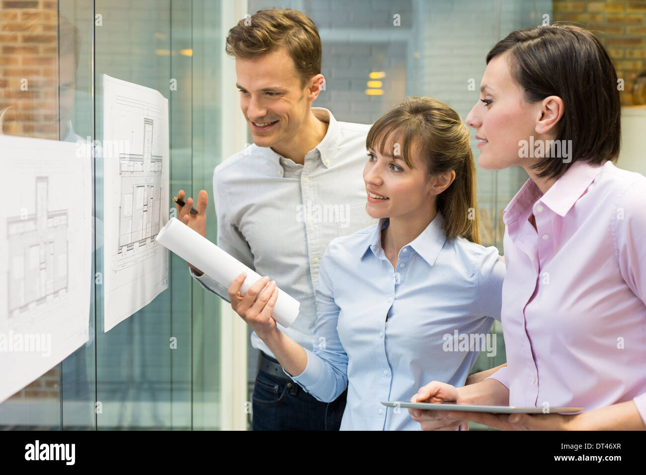 Business man woman plans meeting colleagues tablet pc Stock Photo