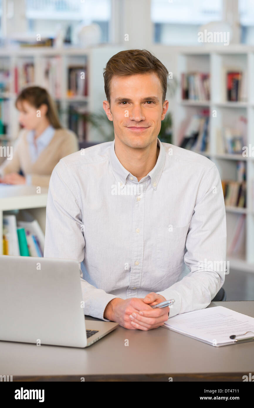 Man Cheerful desk computer young colleagues Stock Photo