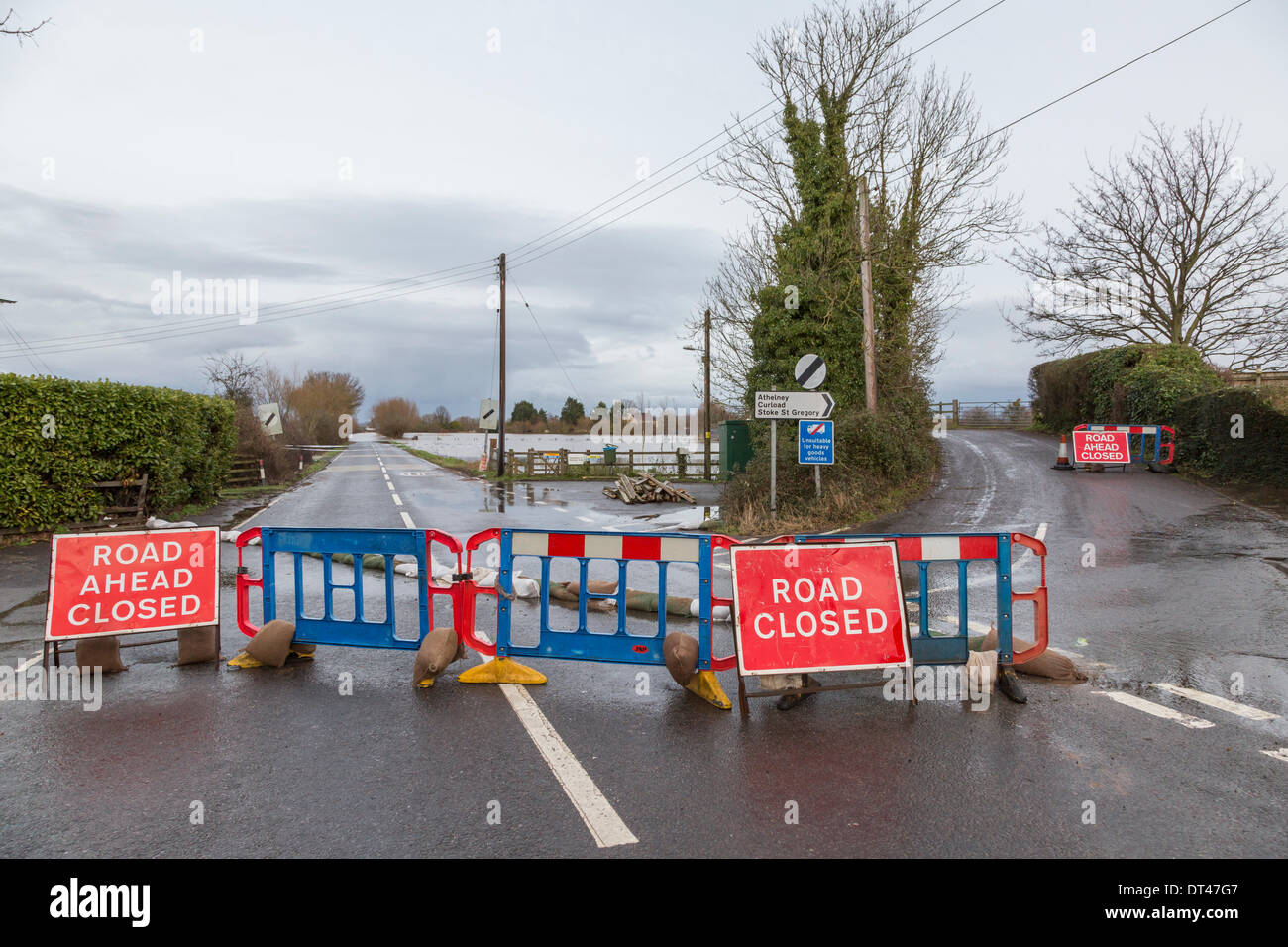 East Lyng, Somerset, UK. 7th February 2014. Road block at the junction between the A361 and Cuts Road at East Lyng in Somerset on 7th February 2014. Water from the rivers Parrett and Tone have burst their banks and flooded sixty five square miles of farmland including several villages. A severe flood alert remains in the area between Lyng and Burrowbridge where there is a danger to life. Water is rising rapidly in the village and has started to flood some houses. Some residents have been asked to evacuate but have decided to stay. Credit:  Nick Cable/Alamy Live News Stock Photo