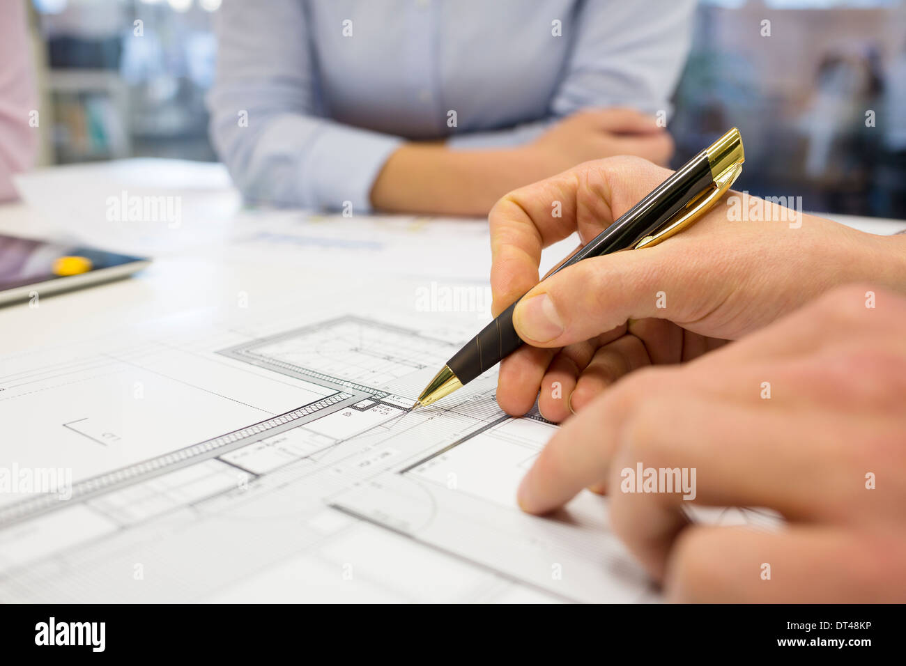 Business team desk architect man woman digital tablet blueprint construction Stock Photo