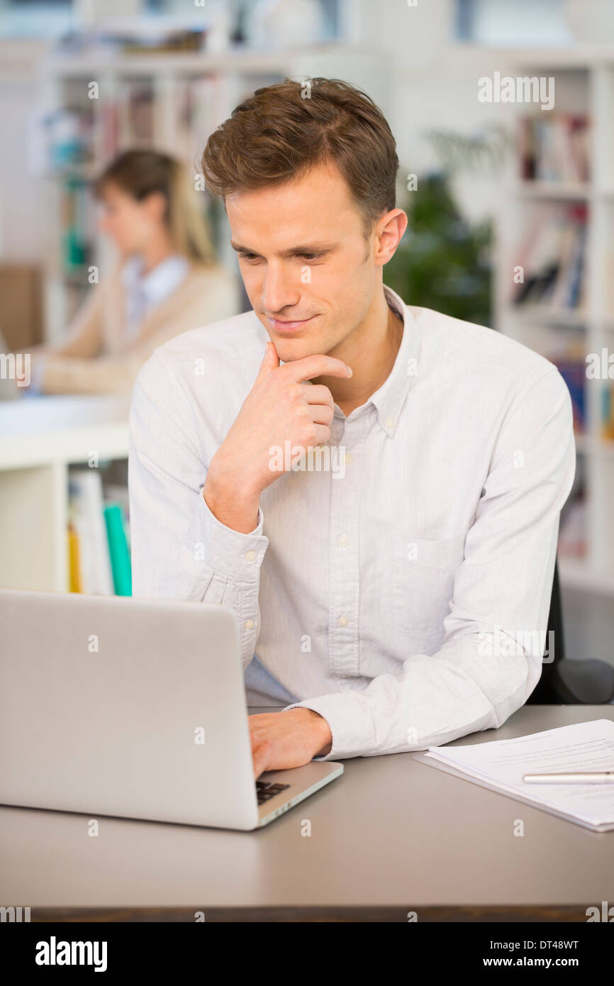 Man student Cheerful desk laptopyoung colleagues Stock Photo