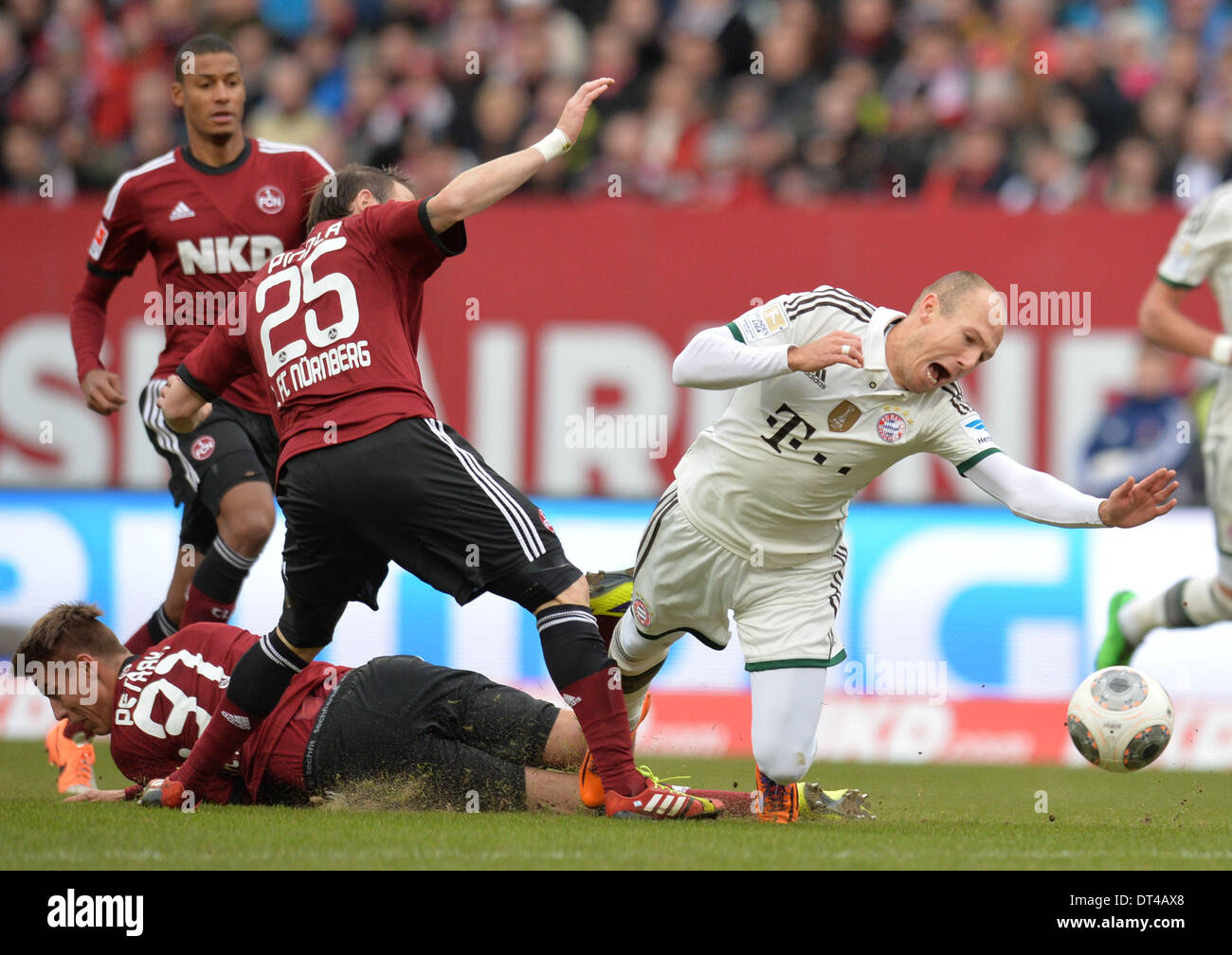 Nuremberg, Germany. 08th Feb, 2014. Munich's Arjen Robben vies for the ball with Nuremberg's Javier Pinola (L) during the Bundesliga soccer match between 1. FC Nuremberg and FC Bayern München at Grundig-Stadium in Nuremberg, Germany, 08 February 2014. Photo: TIMM SCHAMBERGER/DPA (ATTENTION: Due to the accreditation guidelines, the DFL only permits the publication and utilisation of up to 15 pictures per match on the internet and in online media during the match.)/dpa/Alamy Live News Stock Photo
