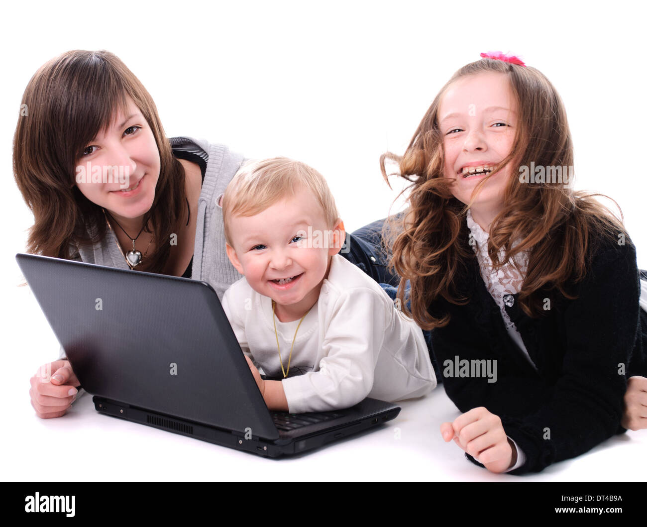 Three children play with laptop, isolated on white Stock Photo