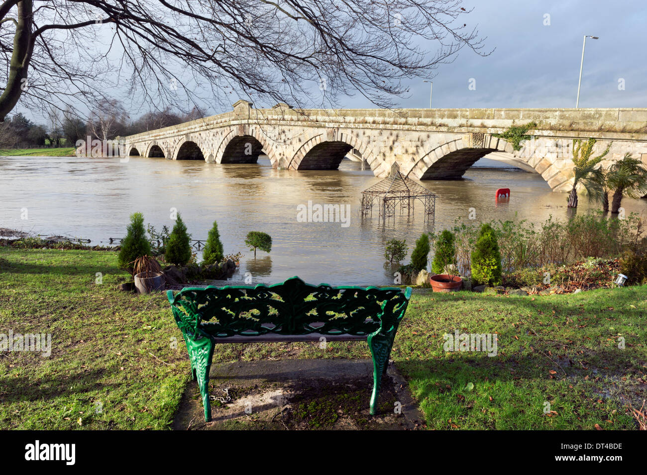 Shropshire, UK. 8th February 2014. The old road bridge and The River Severn at Atcham, near Shrewsbury, Shropshire, seen from the flooded garden of The Mytton & Mermaid Hotel. Credit:  John Bentley/Alamy Live News Stock Photo