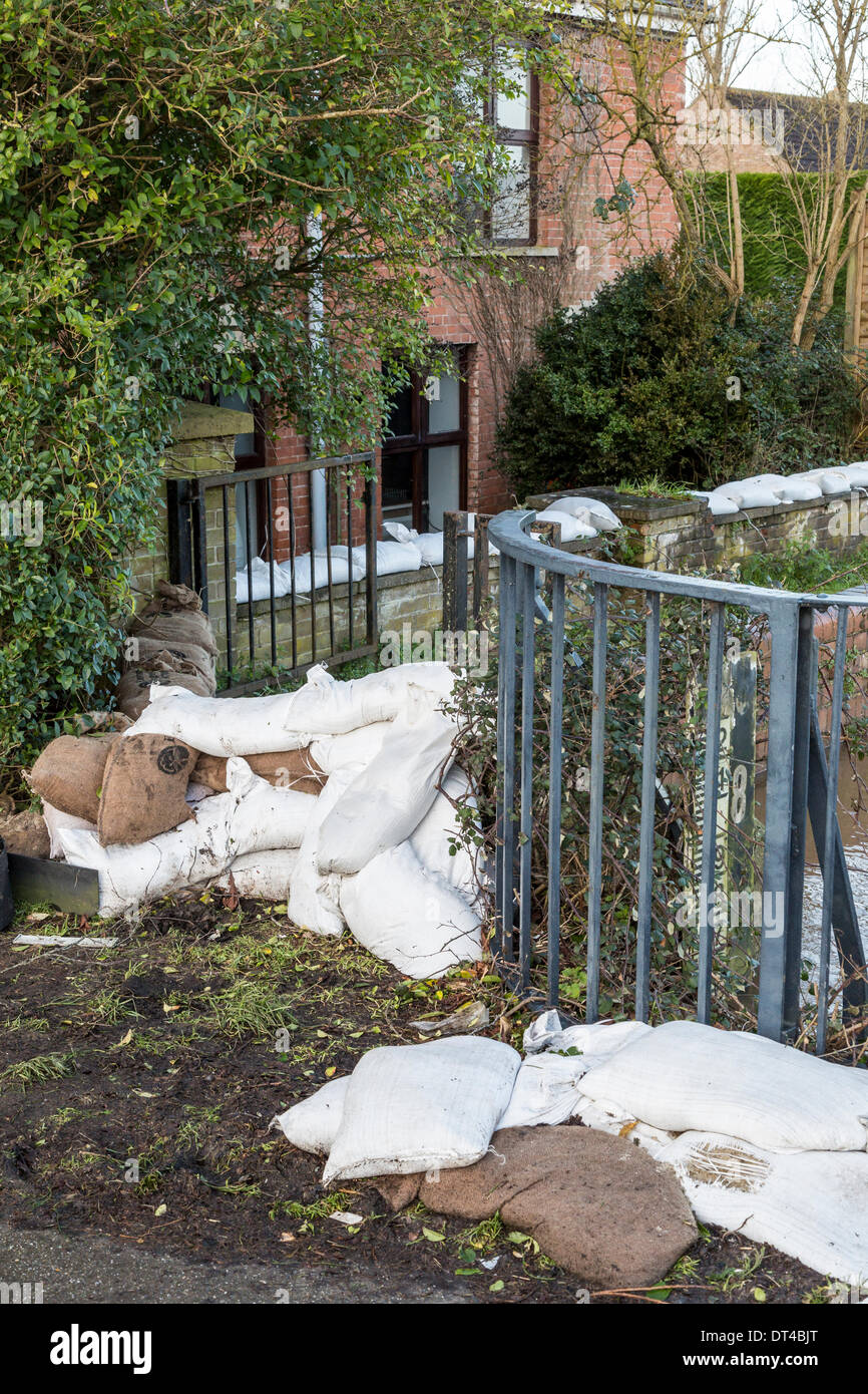 Flood defences at the village of Burrowbridge in Somerset on 8th February 2014. Due to high rainfall, the River Parrett has been unable to cope with the volume of water and has flooded nearby farmland leaving houses underwater.   Here sand bags and ballast try to prevent water entering a private residence. A severe flood alert remains and some occupants have been told to evacuate. Credit:  Nick Cable/Alamy Live News Stock Photo