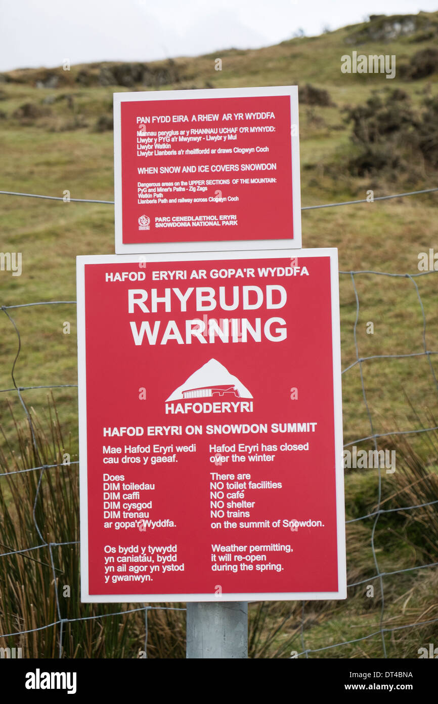 Bilingual warning signs on Llanberis path for closure of Hafod Eryri cafe and hazardous conditions on Mt Snowdon in winter Snowdonia Wales UK Stock Photo