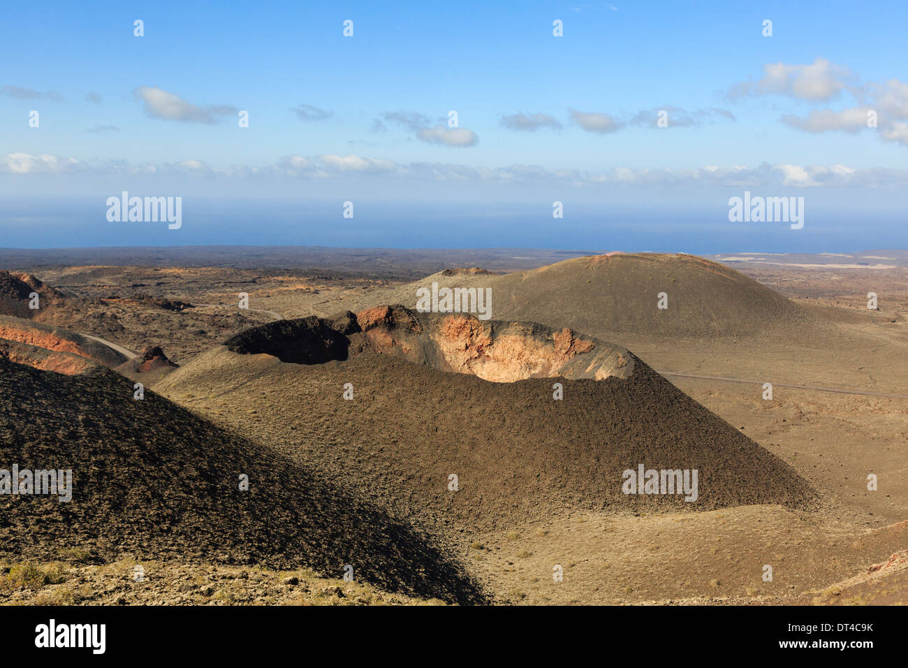 Montanas del Fuego or Fire Mountains and volcanic landscape of lava ash with a crater in Parque Nacional de Timanfaya, Lanzarote Stock Photo