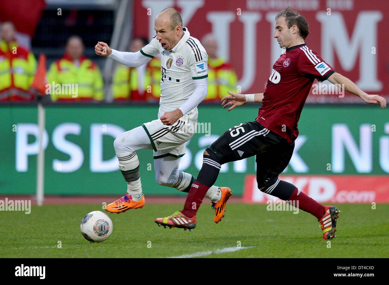 Nuremberg, Germany. 08th Feb, 2014. Munich's Arjen Robben (L) vies for the ball with Nuremberg's Javier Pinola during the Bundesliga soccer match between 1. FC Nuremberg and FC Bayern München at Grundig-Stadium in Nuremberg, Germany, 08 February 2014. Photo: DAVID EBENER/DPA (ATTENTION: Due to the accreditation guidelines, the DFL only permits the publication and utilisation of up to 15 pictures per match on the internet and in online media during the match.)/dpa/Alamy Live News Stock Photo
