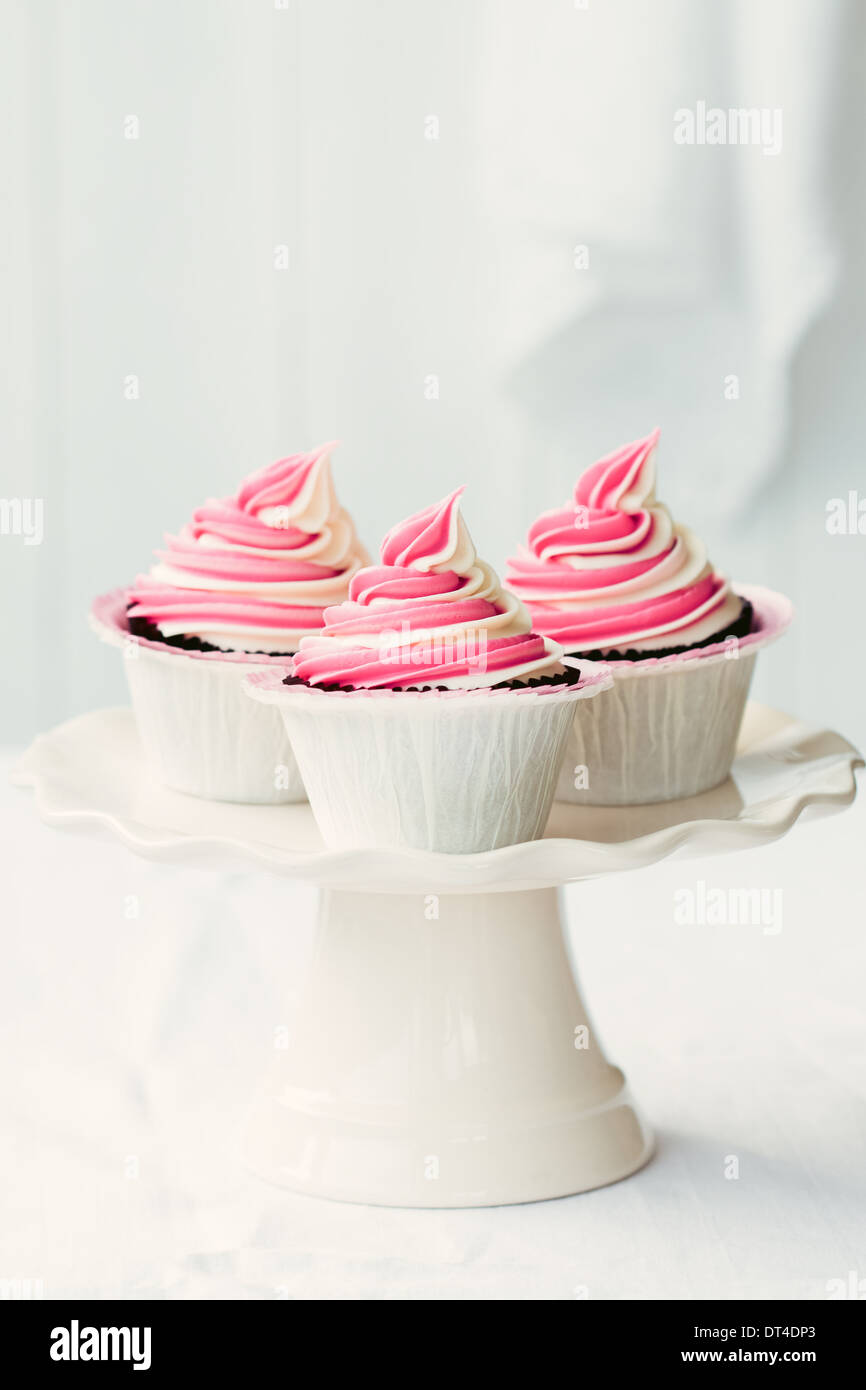 Raspberry ripple cupcakes on a cakestand Stock Photo