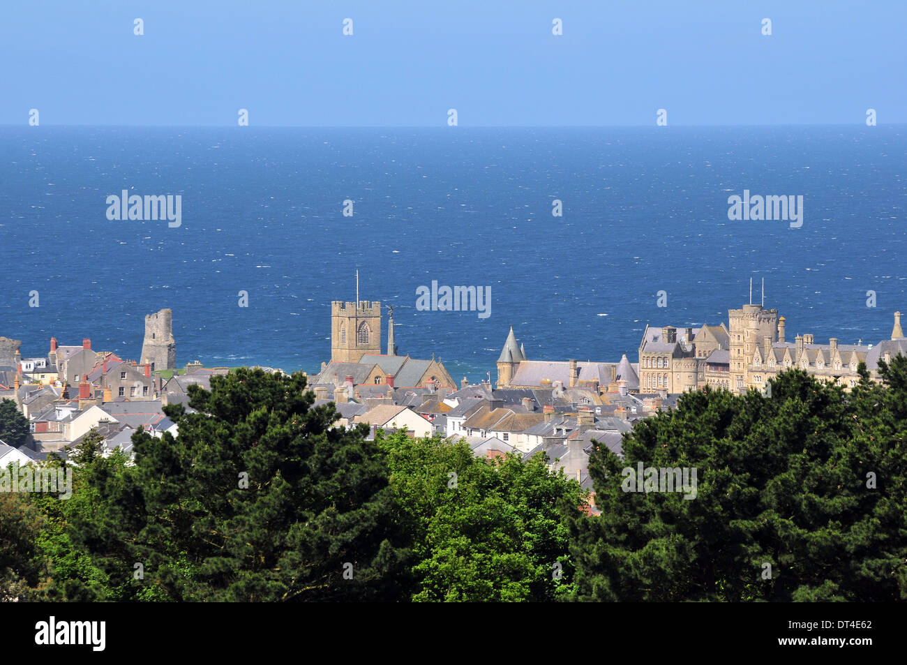 Aberystwyth Castle, St Michaels Church and the Old College of Aberystwyth University against a blue sea on a sunny day in May. Stock Photo