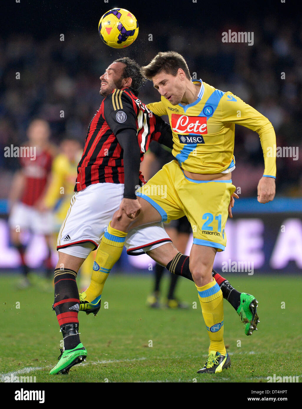 Naples, Italy. 8th Feb, 2014. AC Milan's Gianpaolo Pazzini (L) vies for the ball with Napoli's Federico Fernandez during their Italian Serie A soccer match at San Paolo stadium in Naples, Italy, Feb. 8, 2014. Napoli won 3:1. Credit:  Alberto Lingria/Xinhua/Alamy Live News Stock Photo