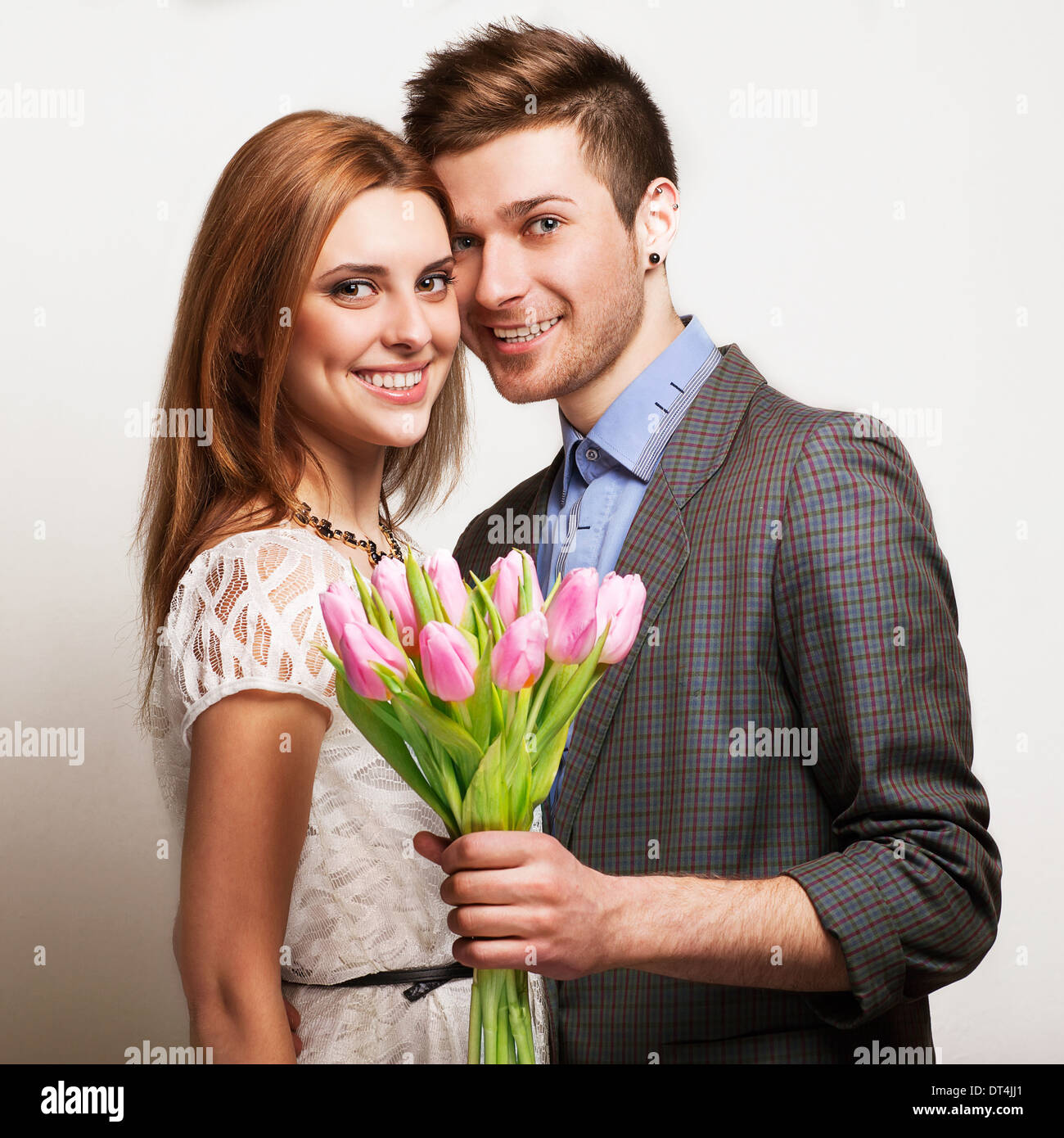couple in love with a bouquet of tulips are close to each other Stock Photo