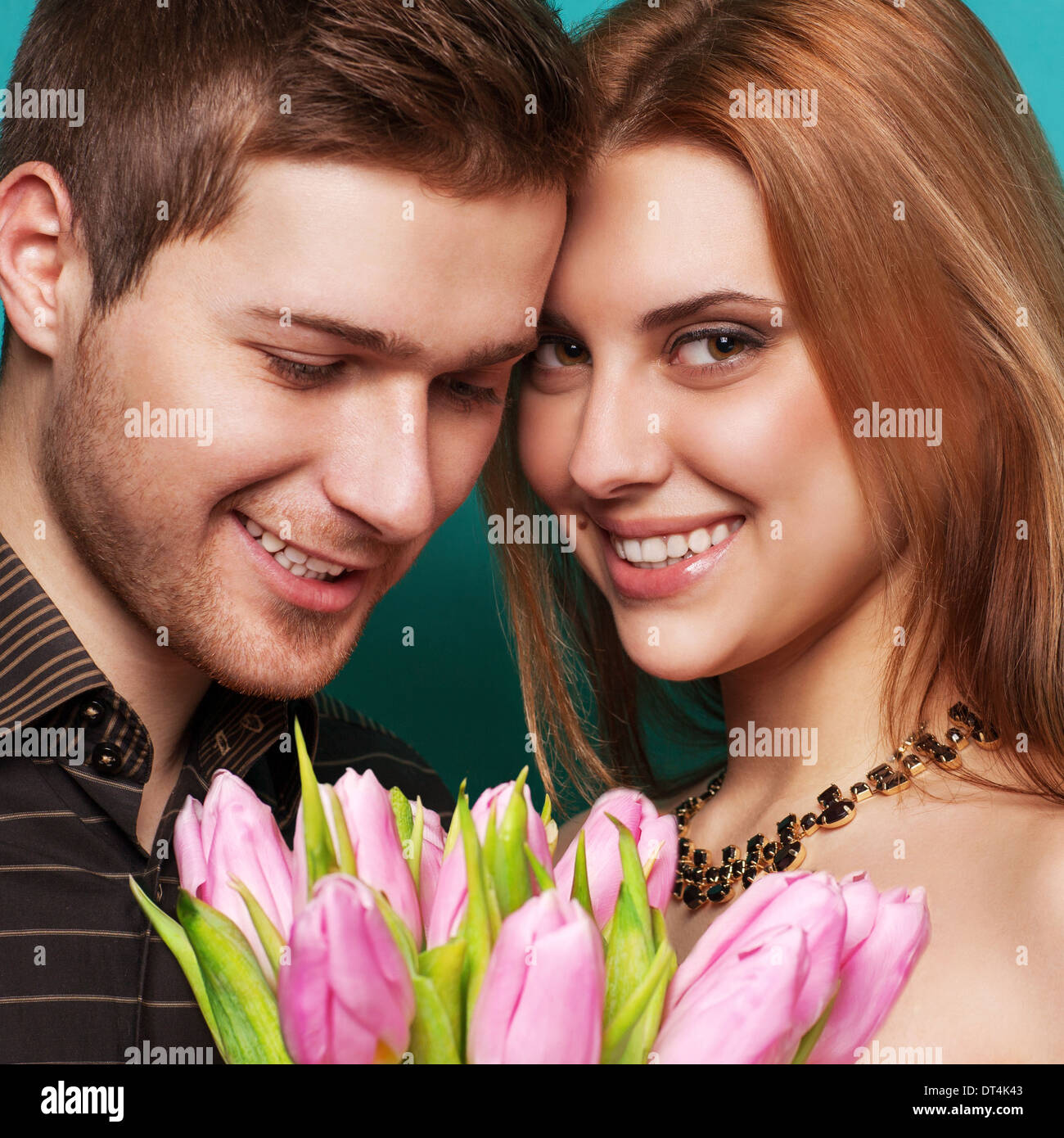 couple in love with a bouquet of tulips are close to each other Stock Photo