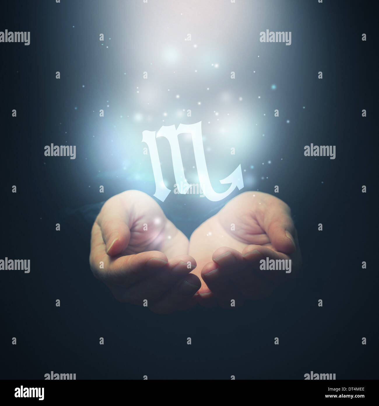Female hands opening to light and holding zodiac sign for Scorpio. Horoscope symbols. Selective focus. Stock Photo