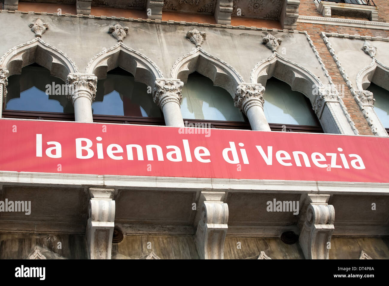 big red poster of Biennale of Venice festival on palace wall Stock Photo