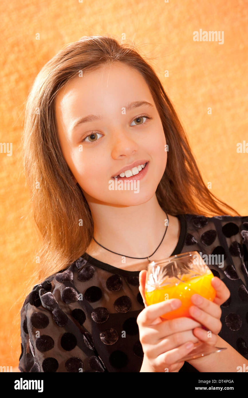 Young girl smiling with a fruit juice Stock Photo Alamy