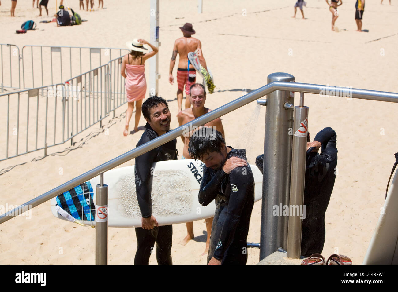 surfers take a beach shower on manly beach,Sydney Stock Photo