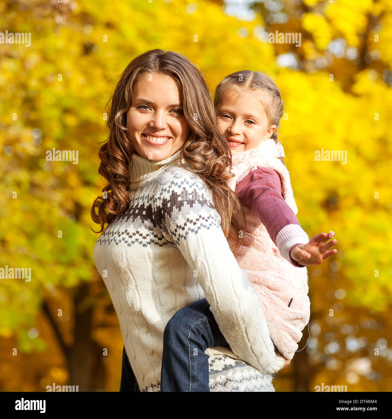 Young mother and her toddler girl have fun in autumn Stock Photo - Alamy