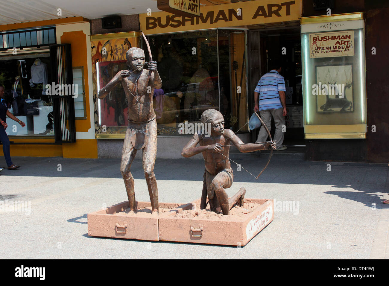 Bronze sculpture of two bushmen with bow and arows outside an Arts and Crafts shop in Windhoek,Namibia.Africa. Stock Photo