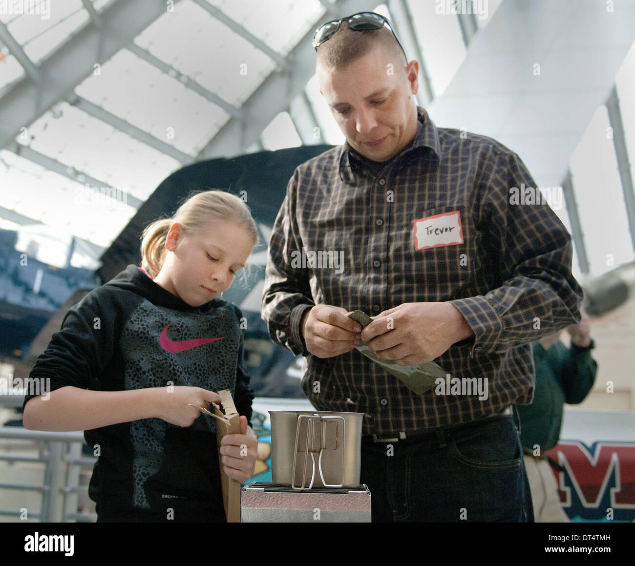 Gunnery Sgt. Trevor Havens and his daughter take part in the National Museum of the Marine Corps Second Annual MRE Cook off by combining prepackaged rations issued service members to create the best tasting meal February 1, 2014 in Triangle, VA. Pre-packaged MRE's or Meals Ready to Eat are known for their ability to deliver nutrition and not flavor. Stock Photo