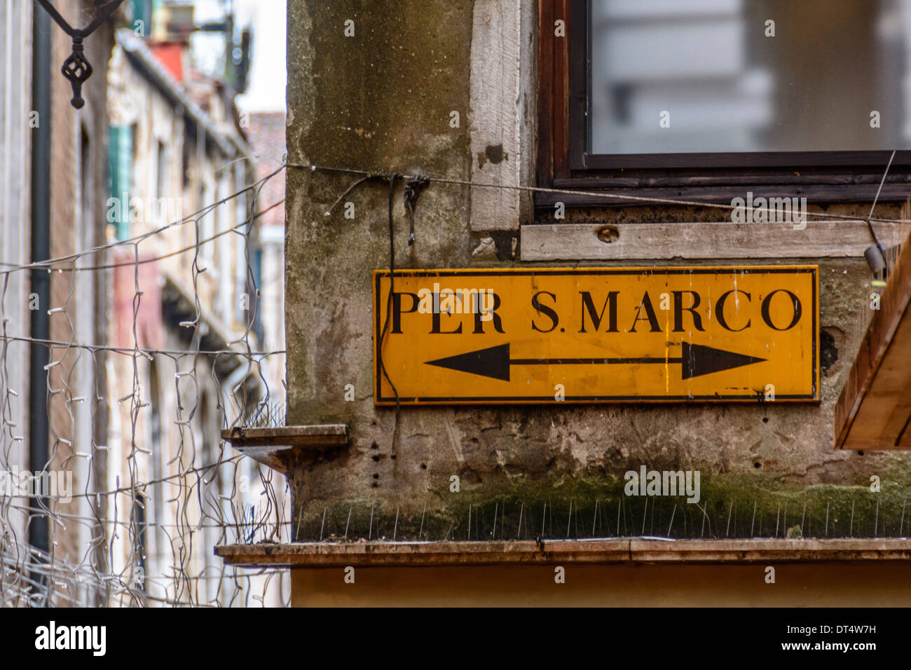 Venice, Italy. Route sign "Per S. Marco" showing the way to St Mark´s Square with an arrow pointing in both directions left and right. Stock Photo
