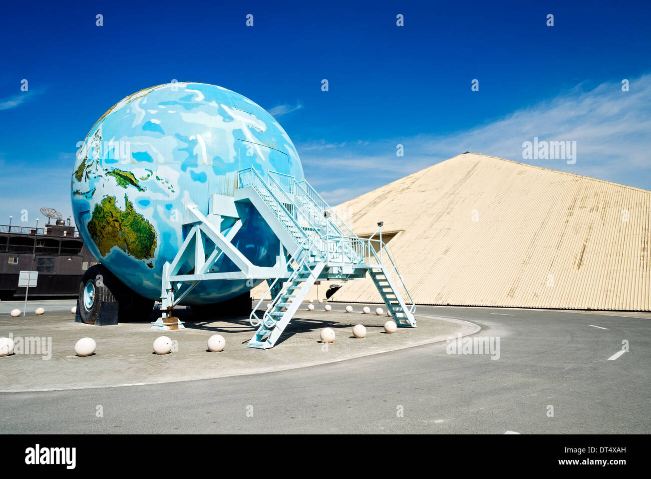 Pyramid shaped Emirates National Auto Museum with Earth shaped large caravan outside Abu Dhabi in United Arab Emirates Stock Photo