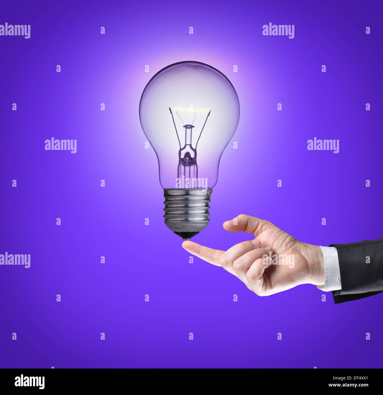 Light bulb on tip of finger on businessman.Purple background Stock ...
