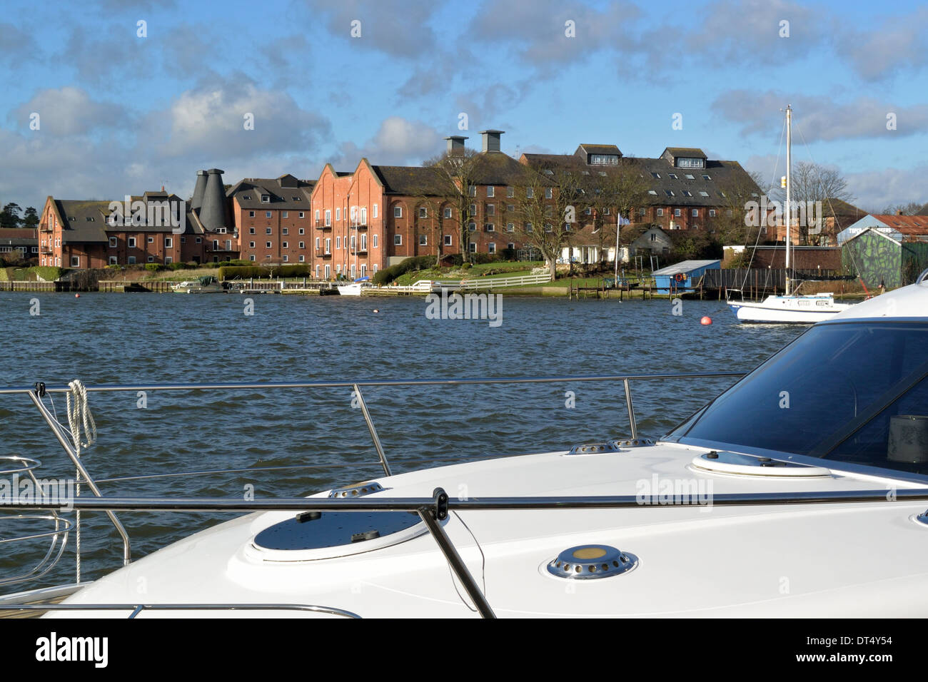 Looking across Oulton Broad, Suffolk, towards the Old Maltings from a motor boat moored at the Wherry Hotel, Broads National Park Stock Photo