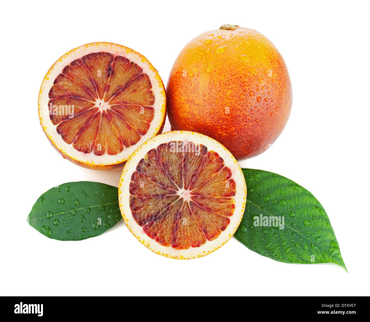 Blood oranges with cut and green leaves isolated on white background. Closeup. Stock Photo