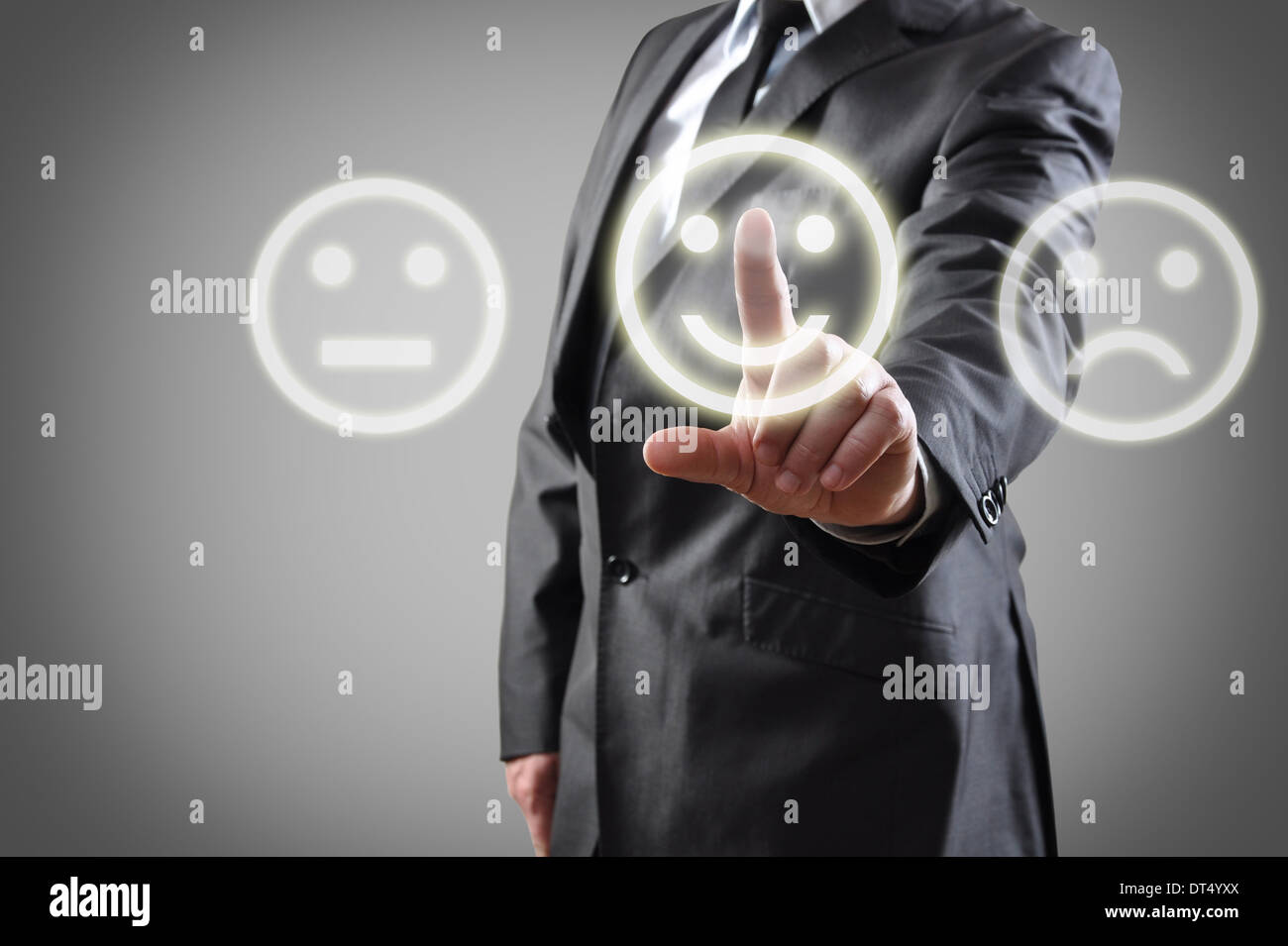 Businessman hand choosing smile on touch screen Stock Photo
