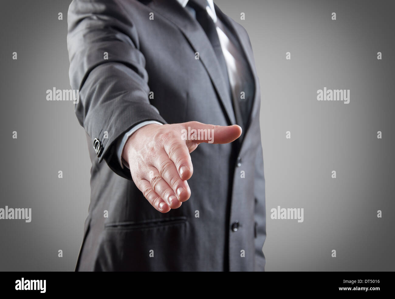 Businessman With Hand Outstretched To Welcome You Stock Photo Alamy