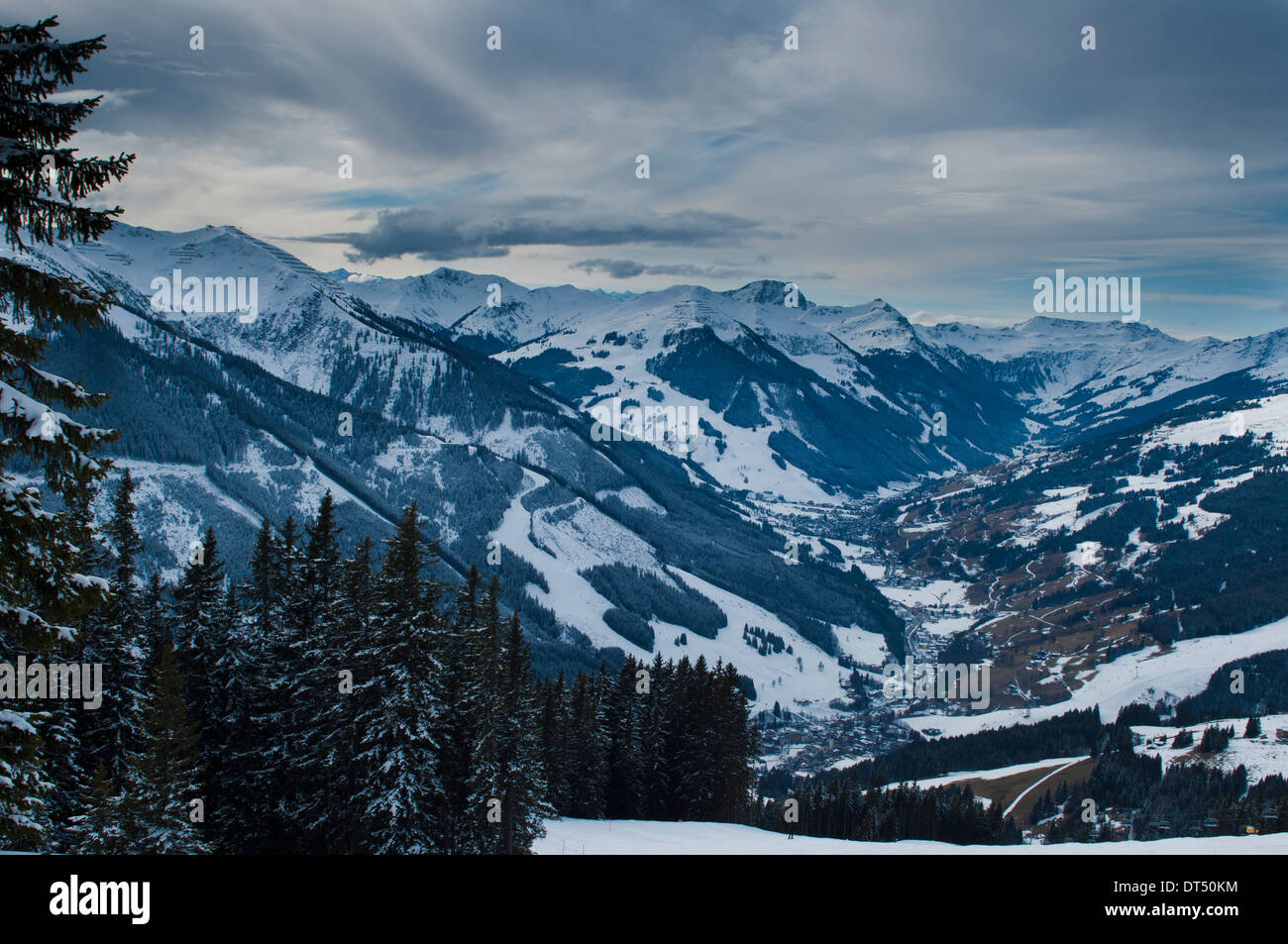 View to Austrian Ski resorts Saalbach and Hinterglemm nestling in an alpine valley, flanked by several peaks Stock Photo