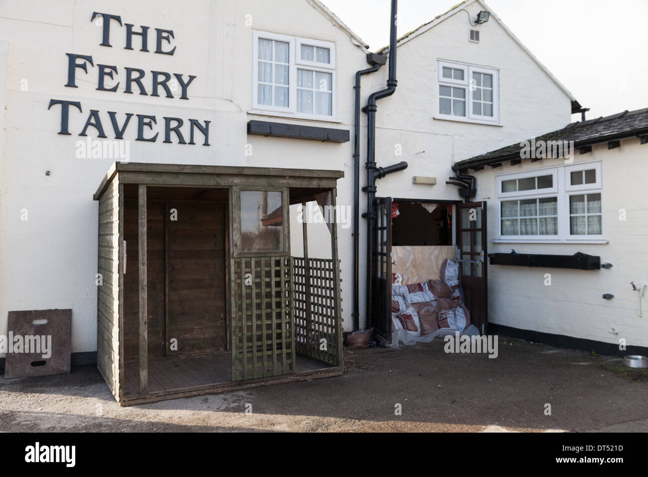 The doors to the Ferry Tavern in Cheshire are reinforced with sandbags and boards ahead of expected floods. Stock Photo