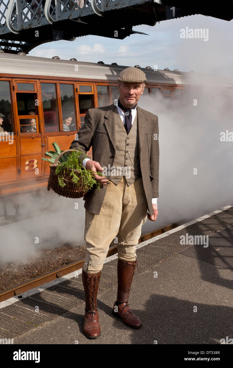 A farmer in 1940's costume at a railway station Stock Photo