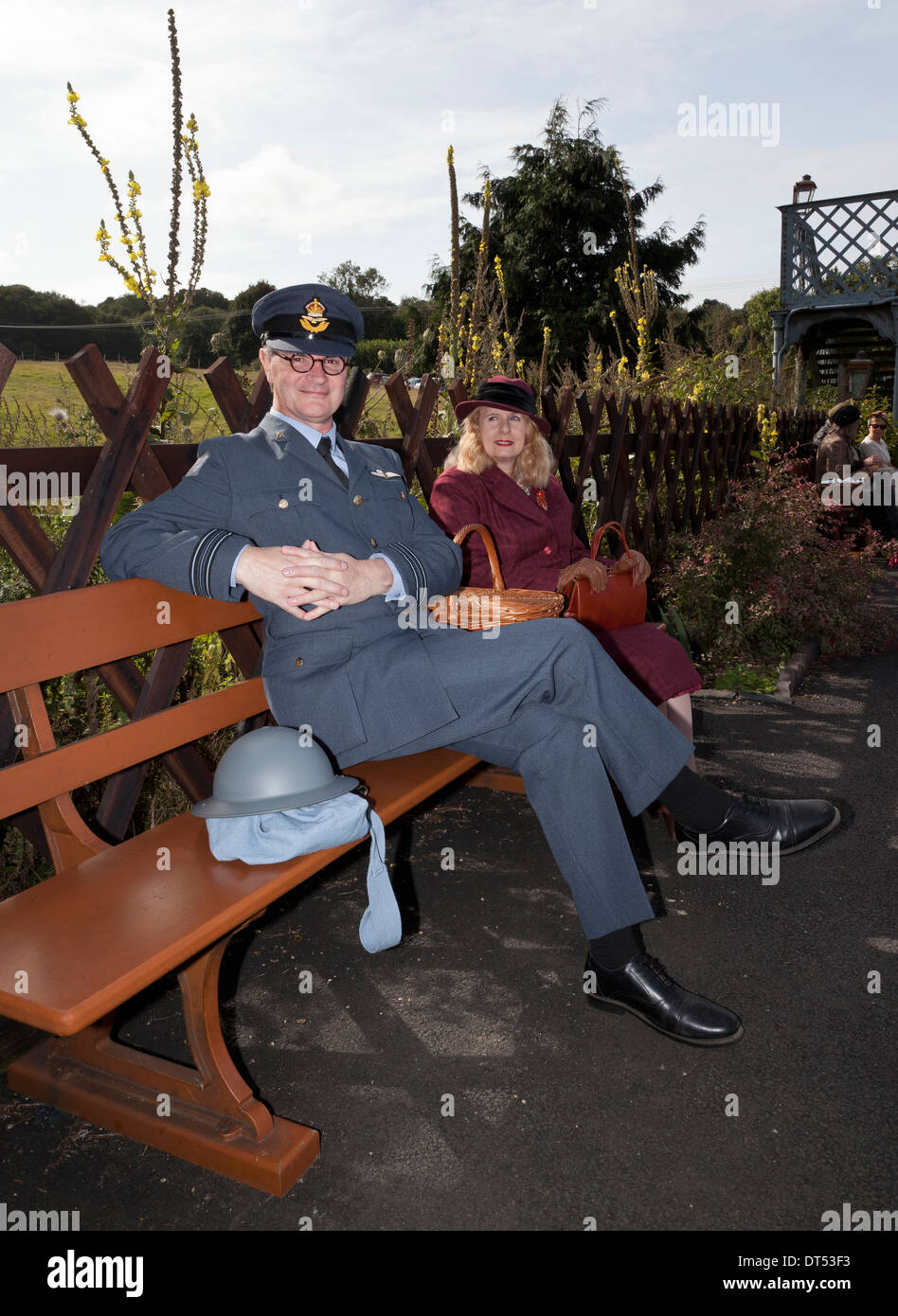 Two people in 1940's costume waiting at a railway station Stock Photo