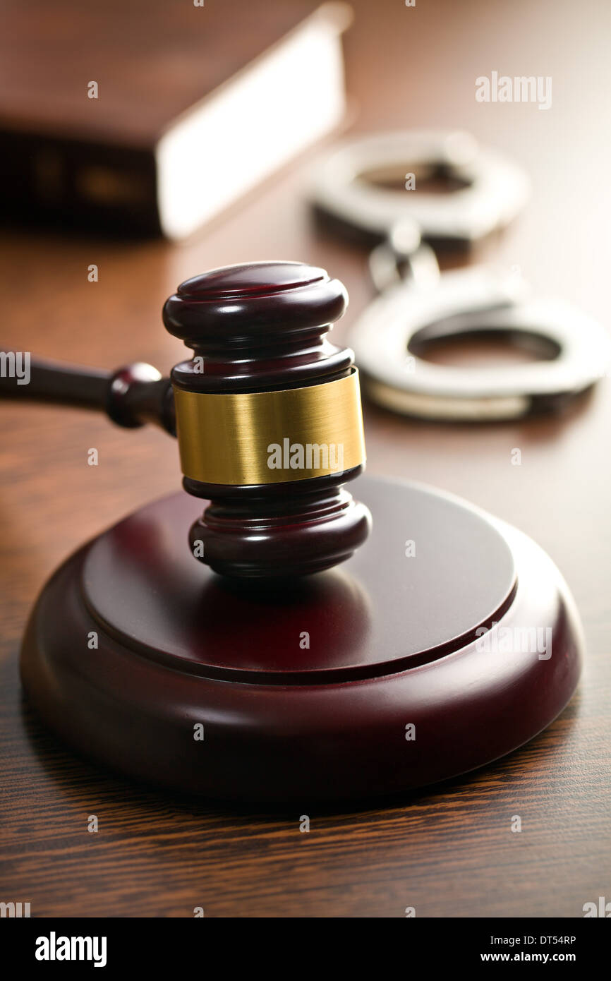 judge gavel with handcuffs on wooden table Stock Photo