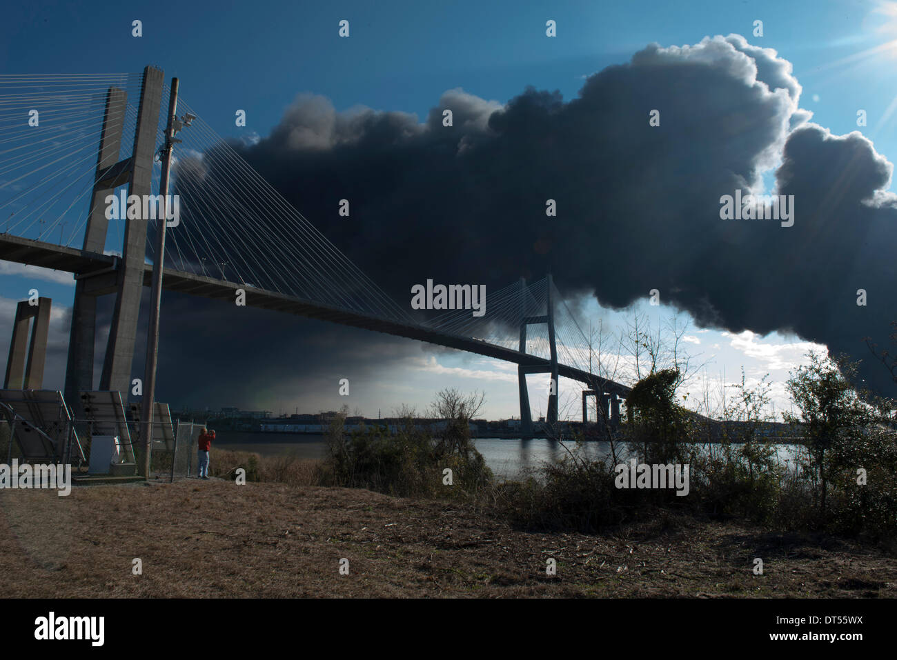 Savannah, Georgia, USA. 8th Fen, 2014. Onlooker photographs the rising smoke from a warehouse fire at the Port of Savannah in Savannah, Georgia, U.S.A., on Saturday, February 8, 2014. Firefighters worked to contain and extinguish the blaze that erupted at the port’s Ocean Terminal not far from downtown Savannah. Credit:  JT Blatty/Alamy Live News Stock Photo