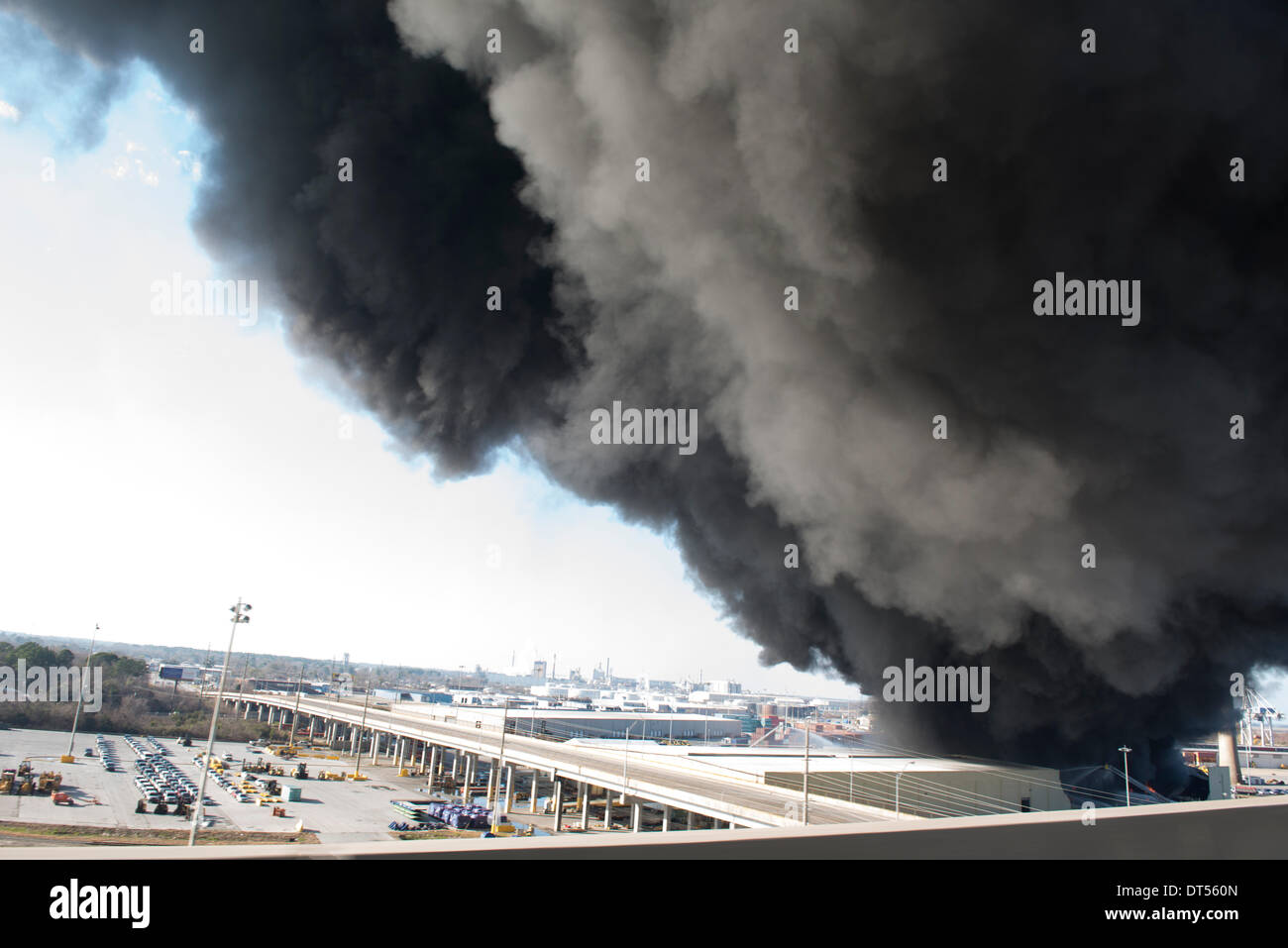 Savannah, Georgia, USA. 8th Fen, 2014. A warehouse fire at the Port of Savannah sends black smoke over Savannah, Georgia, U.S.A., on Saturday, February 8, 2014. Firefighters worked to contain and extinguish the blaze that erupted at the port’s Ocean Terminal not far from downtown Savannah. Credit:  JT Blatty/Alamy Live News Stock Photo