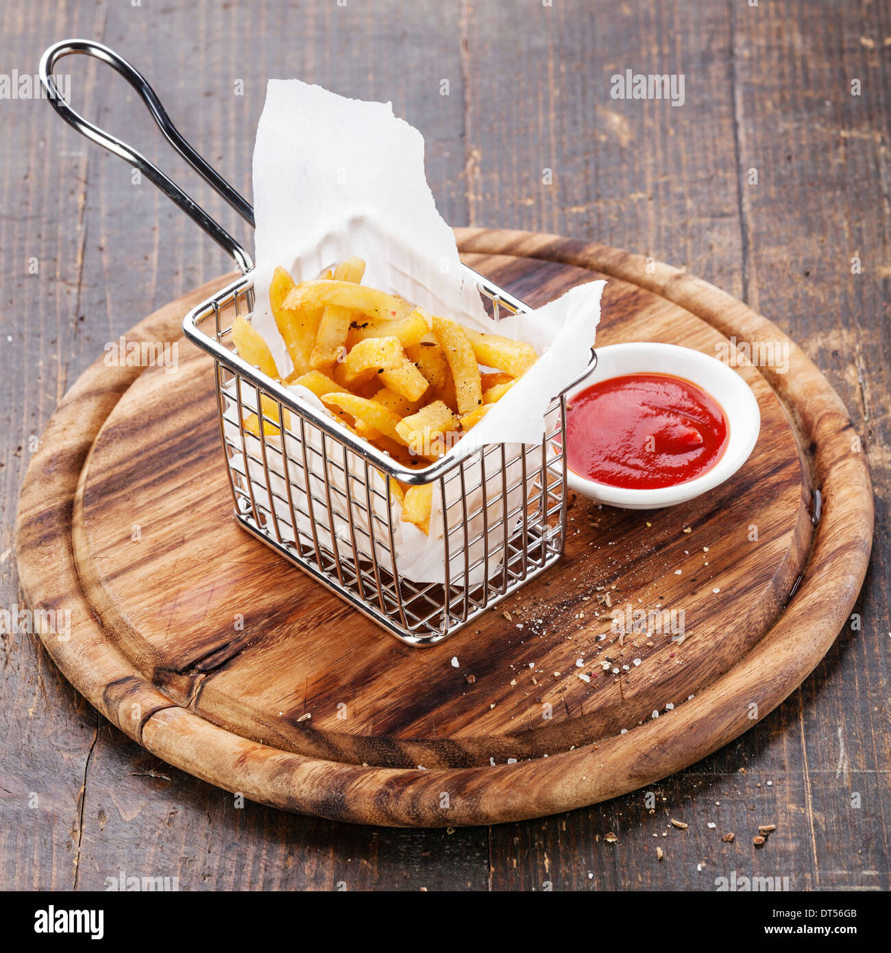 French fries in baskets for serving on wooden background Stock Photo