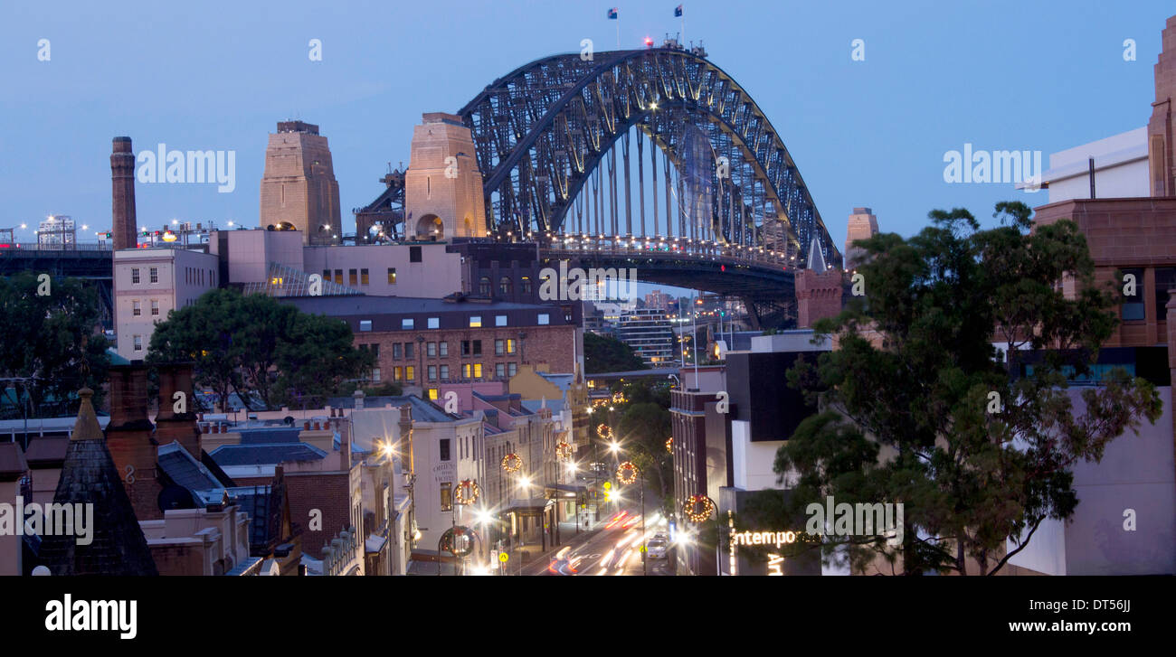 View along George Street in The Rocks historic district to Sydney Harbour Bridge at night Sydney New South Wales NSW Australia Stock Photo