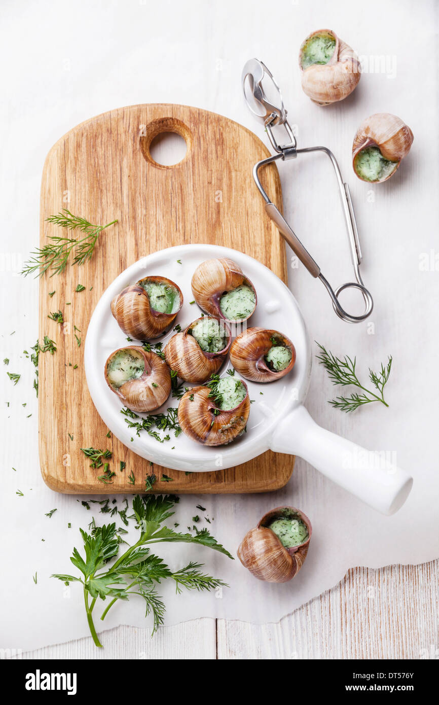 Preparation of snails with garlic butter sauce and fresh greens Stock