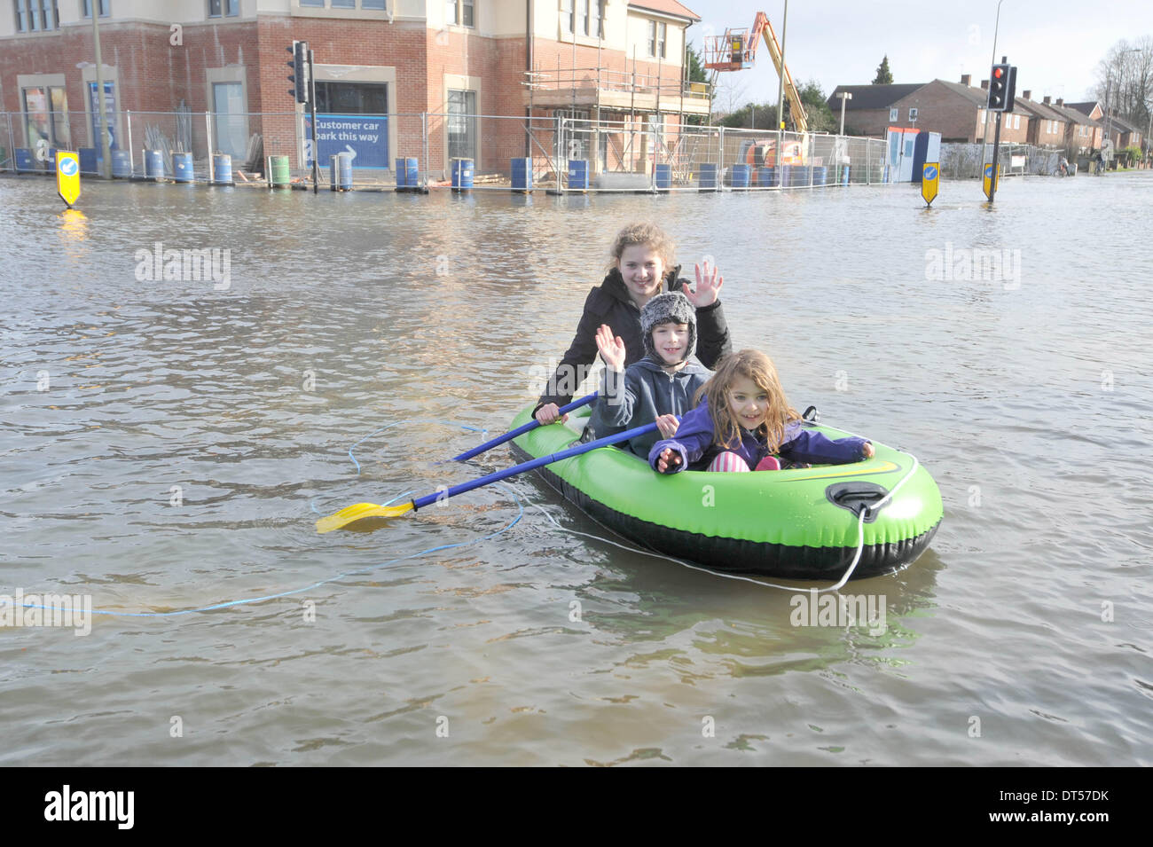 Oxford, UK. 9th Feb, 2014. Boating on the flooded Abingdon Road in Oxford today Back to front: Isabella Bowley 12, Max Bridson -Jones 8, Lucia Bowley 6, in a dinghy. The stormy winter weather has caused widespread flooding across the South and West of the UK. Credit:  Denis Kennedy/Alamy Live News Stock Photo