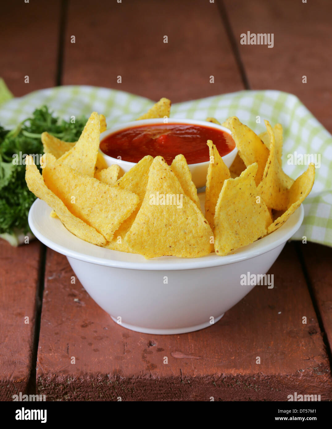 corn tortilla chips in a bowl with tomato sauce Stock Photo Alamy