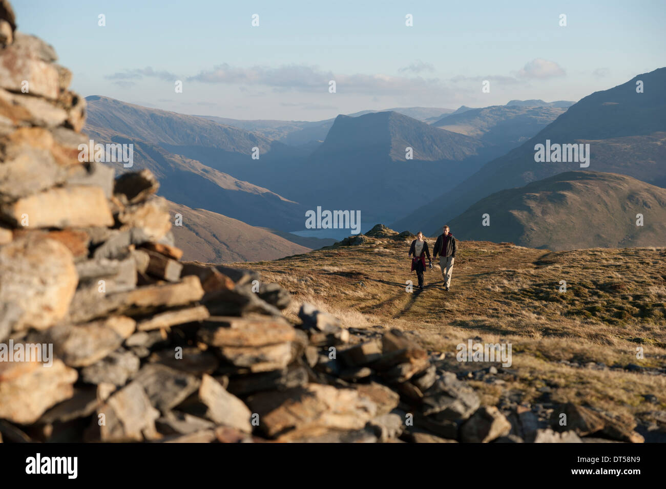 A couple walking up Blake fell. The shot is taken from the summit ...