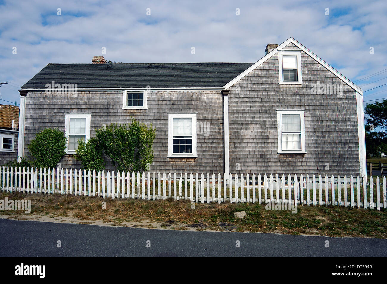 A shingled home behind a white fence on Nantucket, Massachusetts, United States Stock Photo