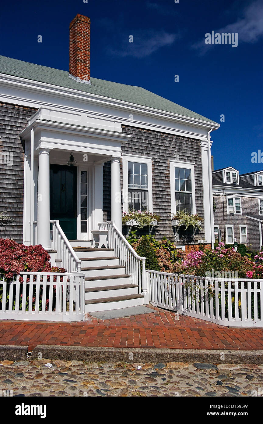 A pretty shingled house on a cobblestone street on Nantucket Island, Massachusetts, United States Stock Photo