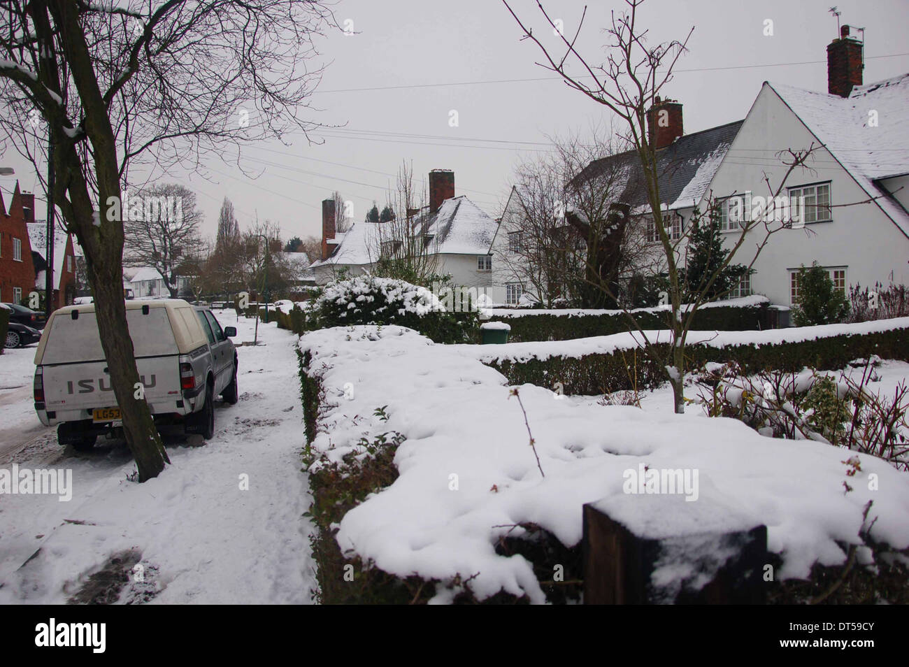 Snow covered edge in Goldsmith Lane during winter at Kingsbury, london, England, Uk Stock Photo